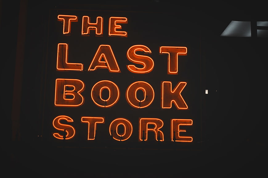 Glowing Orange Neon Sign Reading The Last Book Store