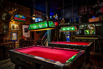 Retro Billiards Room with Red Felt Tables and Neon Signs