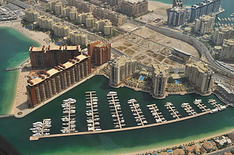 Aerial view of Dubai marina with luxury yachts and modern skyscrapers