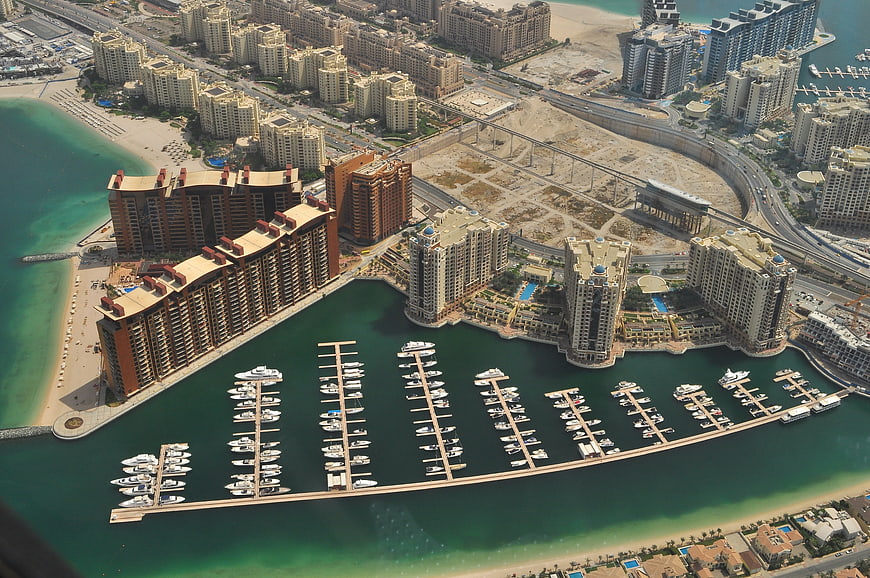 Aerial view of Dubai marina with luxury yachts and modern skyscrapers