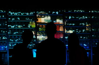 Silhouettes of people in front of glowing jars