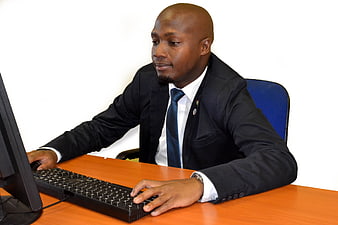 Professional African businessman working at computer in office