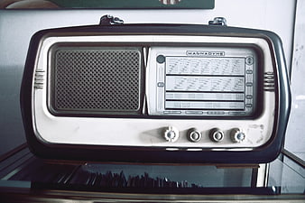 Vintage Magnadyne Transistor Radio on Glass Shelf