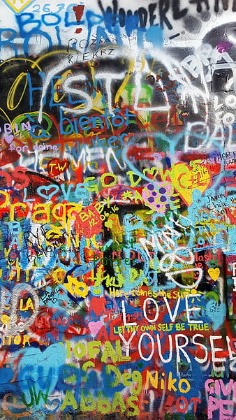 Colorful graffiti wall with peace messages and art