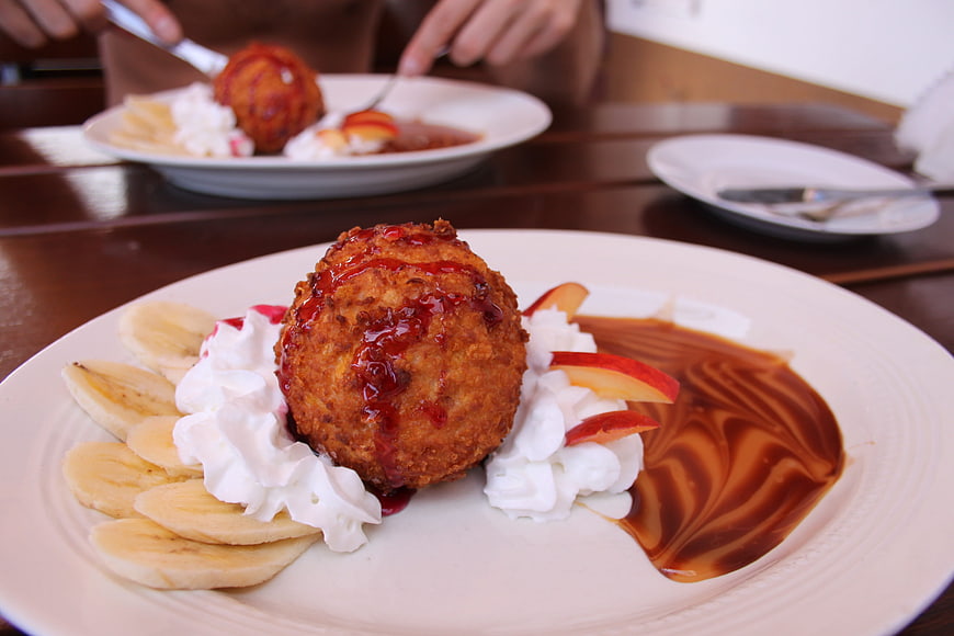Fried Apple Dumpling Dessert with Whipped Cream and Banana