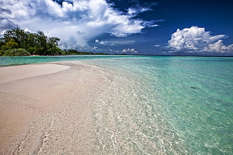 Tropical white sand beach with turquoise water and blue sky