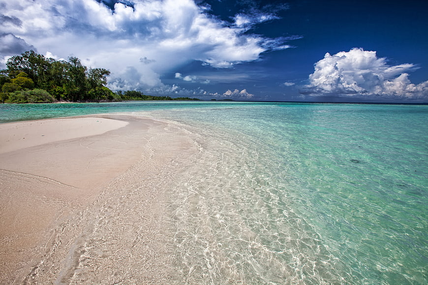 Tropical white sand beach with turquoise water and blue sky