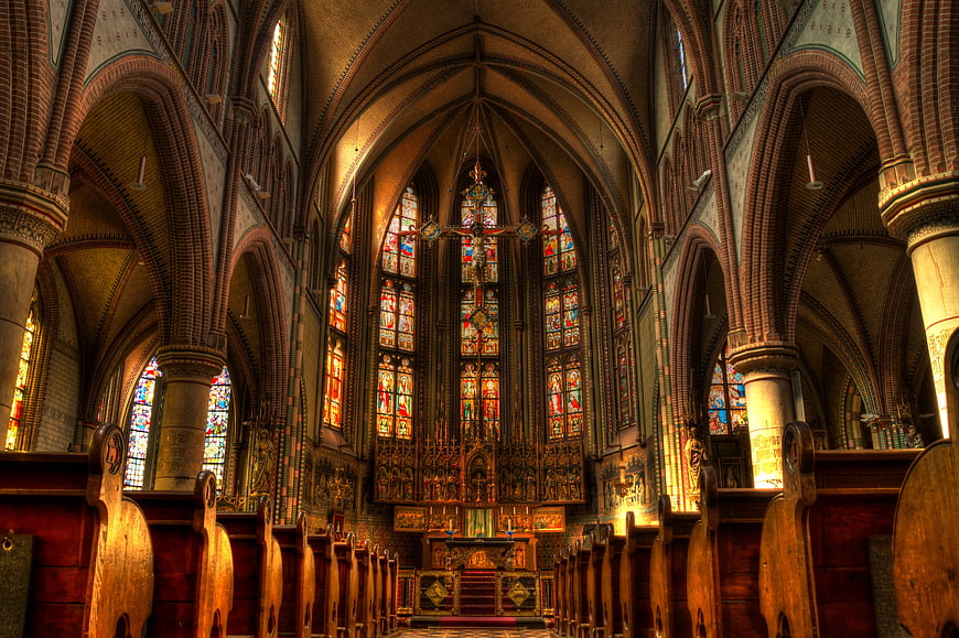 Interior of Gothic Cathedral with Stained Glass Windows and Altar