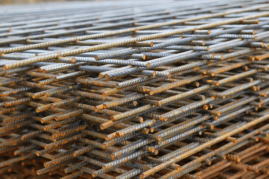 Stack of rusty steel rebar rods for construction