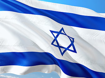 Waving Israeli Flag Against Blue Sky