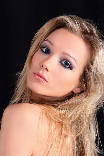 Studio Portrait Of A Young Blonde Woman With Dramatic Eye Makeup