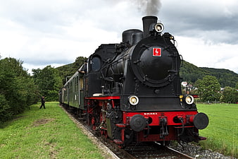 Vintage Black Steam Locomotive on Rural Railway Tracks