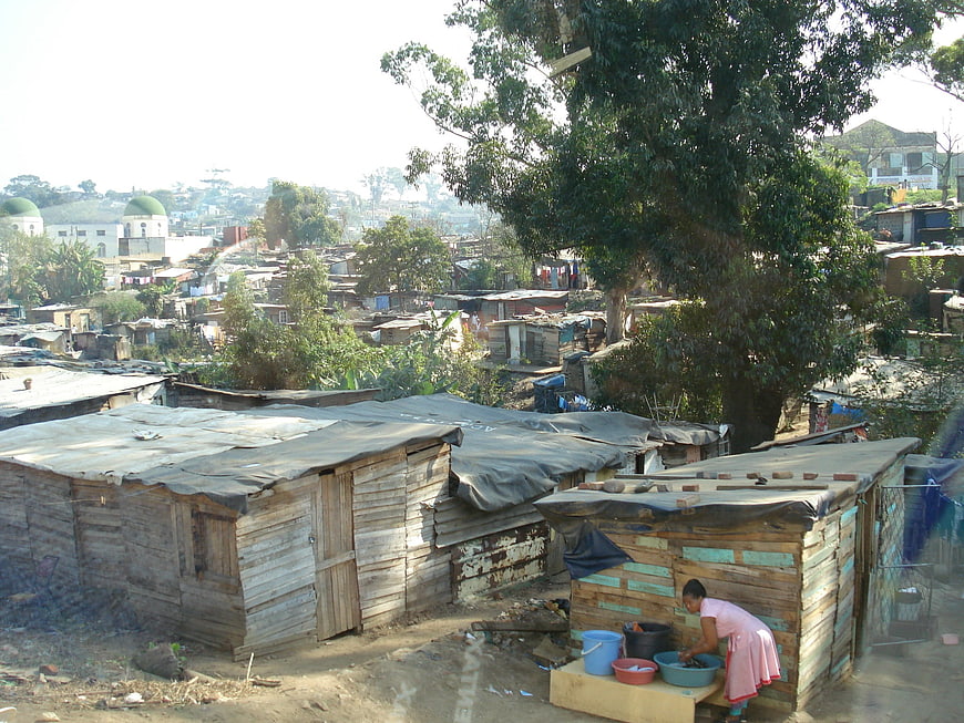 Woman washing clothes in a shanty town settlement