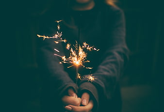 Person Holding Sparkler at Night