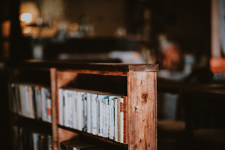 Close-up of wooden bookshelf with books in cozy interior