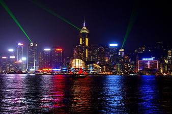 Hong Kong Victoria Harbour Night Skyline With Green Laser Beams And Water Reflections
