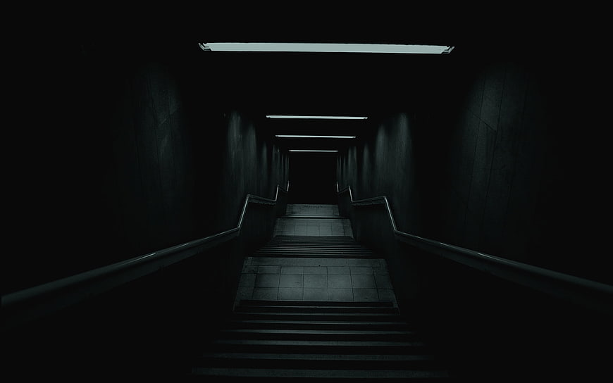 Dark atmospheric staircase with leading lines and moody lighting