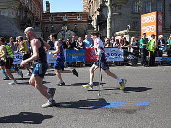 Paralympic runner with prosthetic legs competing in a city marathon race