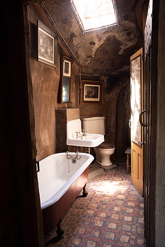 Rustic vintage bathroom with clawfoot tub and skylight