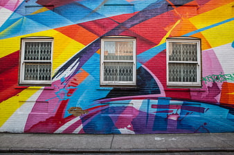 Vibrant Geometric Street Art Mural On Brick Building Facade