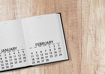 Open 2018 Calendar Showing January and February on Wooden Desk