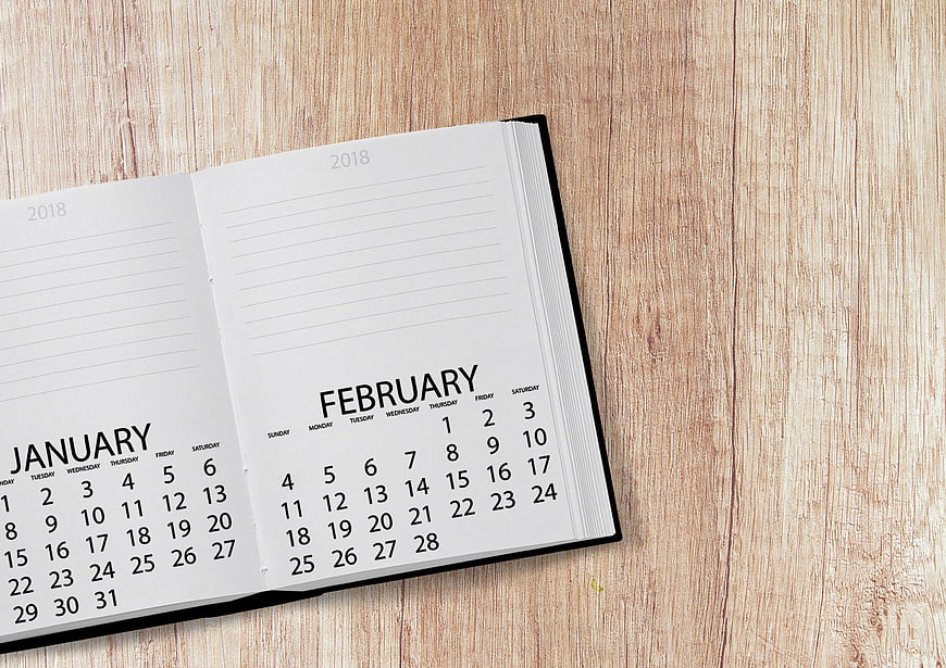 Open 2018 Calendar Showing January and February on Wooden Desk