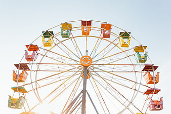 Colorful Ferris Wheel Against Bright Sky