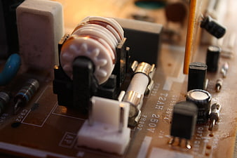 Close-up of vintage circuit board with coil and fuse
