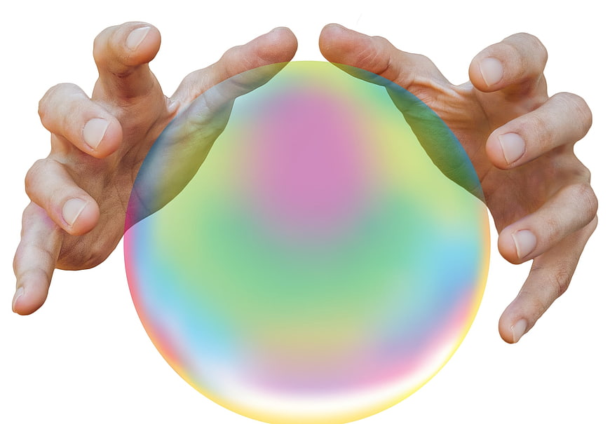 Hands holding colorful crystal ball on white background