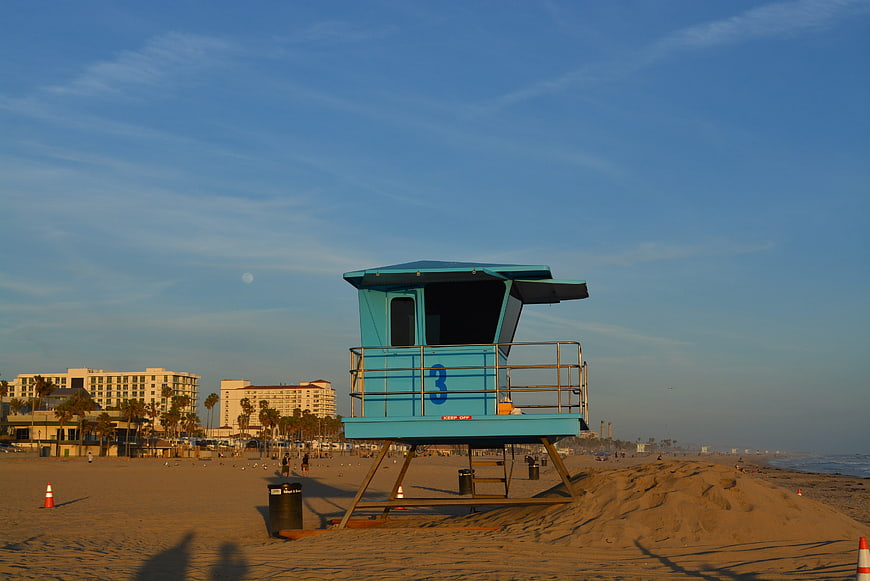Blue Lifeguard Tower on Sandy Beach at Sunset