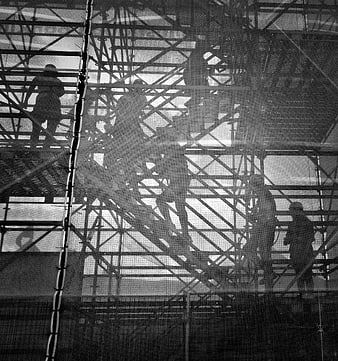 Black and white construction workers on scaffolding