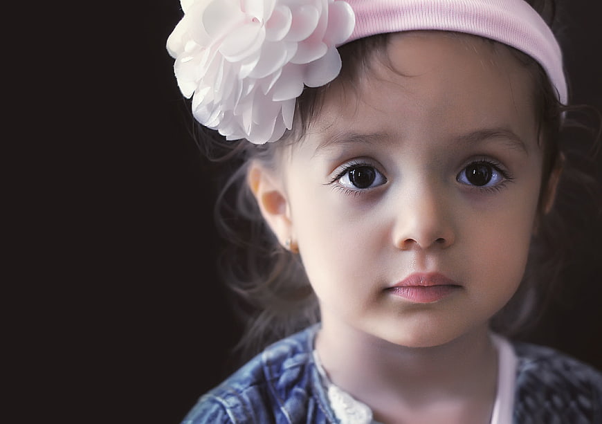 Portrait of a young girl with a white flower headband