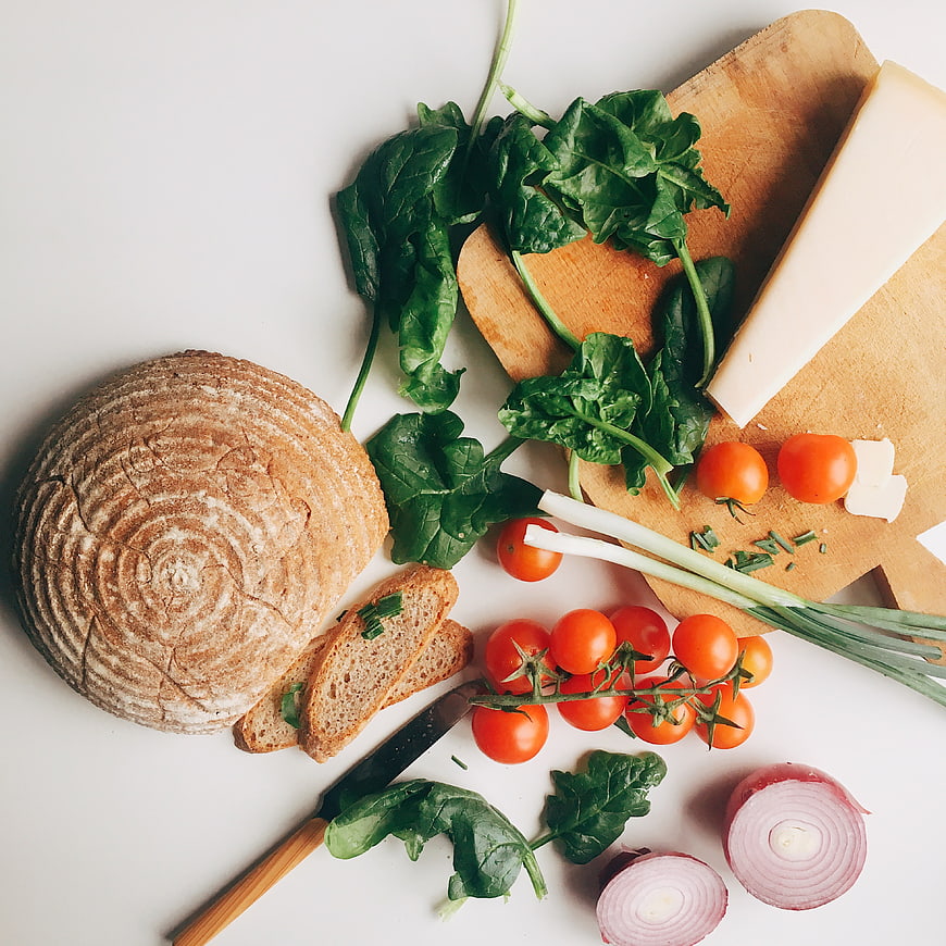 Top view of fresh salad ingredients with artisan bread
