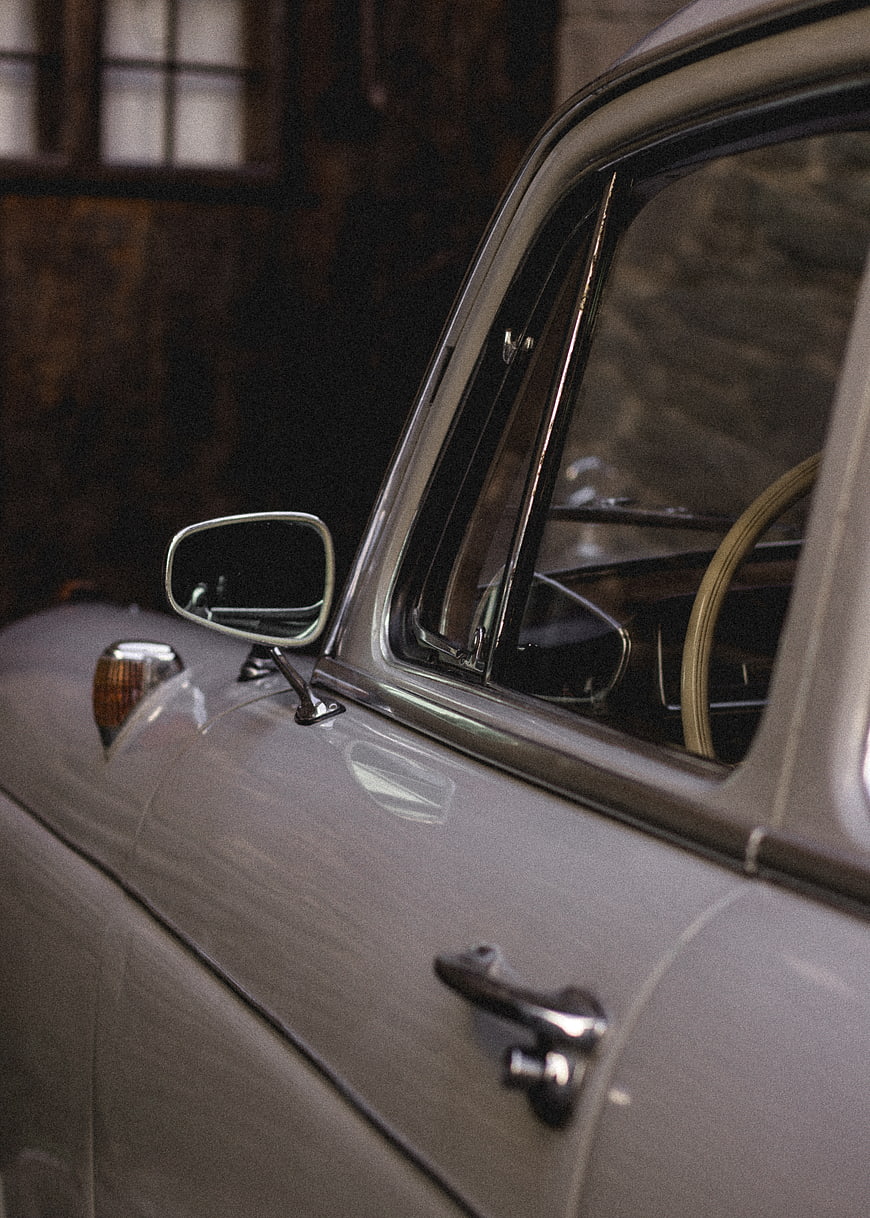Close-up of vintage car door and side mirror