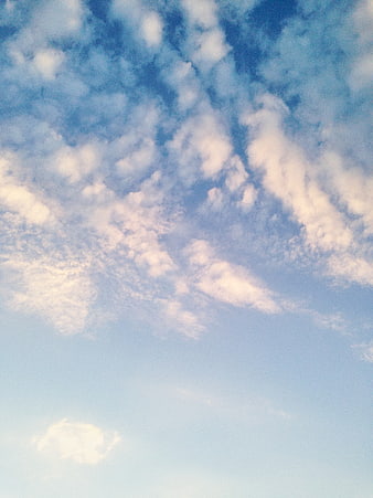 Fluffy white clouds against a blue sky background