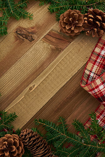 Rustic Christmas Background with Pine Cones and Plaid Blanket