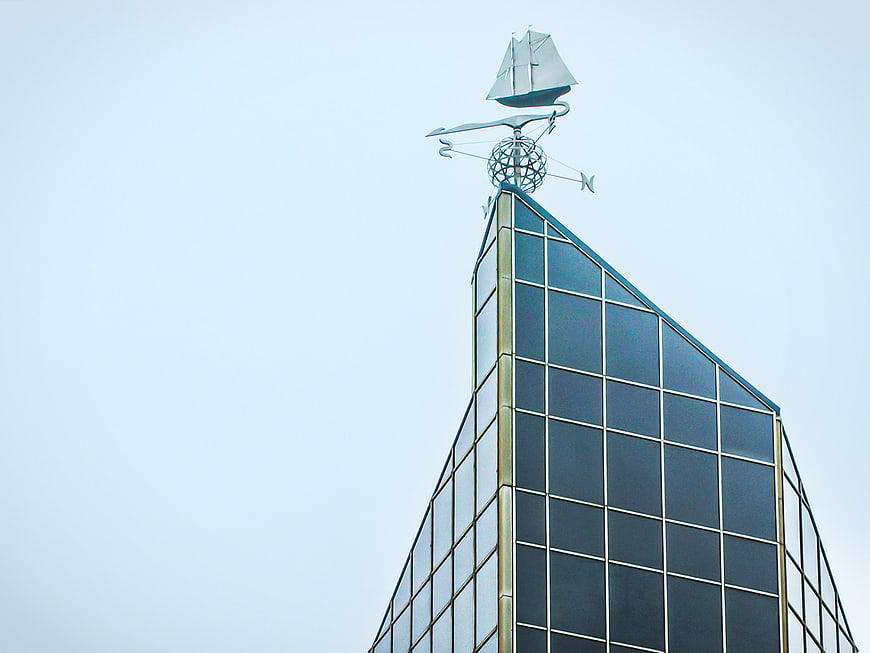 Modern Glass Building Top with Sailboat Weather Vane