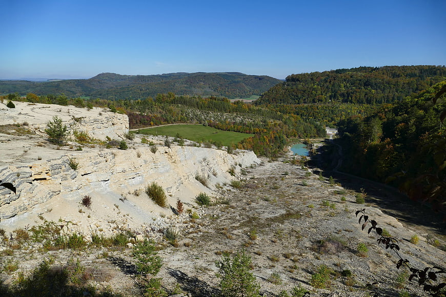 Aerial view of abandoned limestone quarry with autumn forest