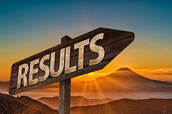 Wooden Results Sign Against Mountain Sunset