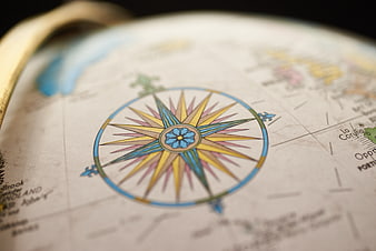 Close-up of vintage globe compass rose with shallow depth of field