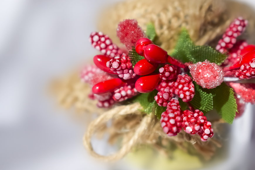 Close-up of red and white Christmas berry decoration with twine