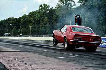Red Muscle Car Wheelie on Drag Strip