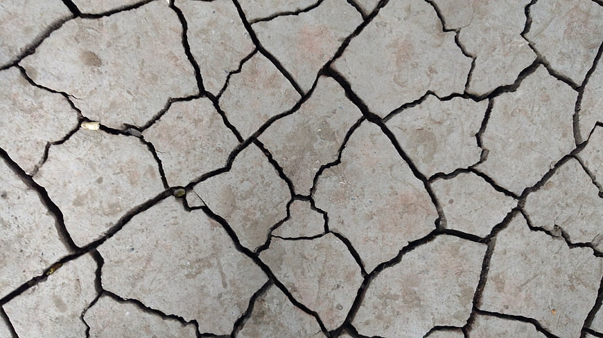 Close-up of cracked dry earth texture background