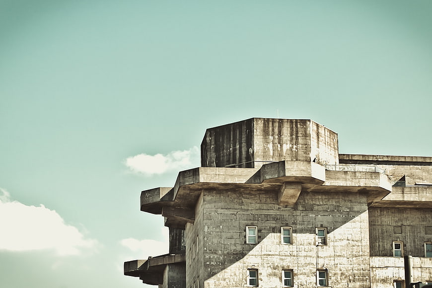 Weathered concrete bunker architecture against teal sky