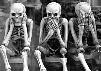 Three Skeletons in See No Evil Pose