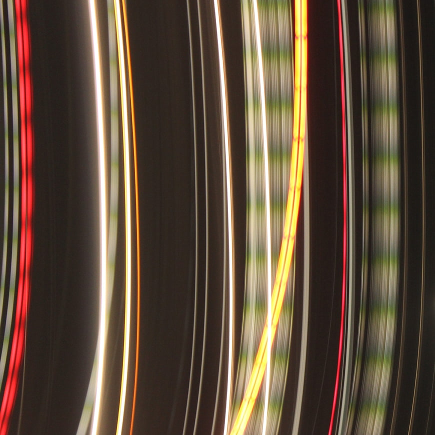 Abstract vertical light streaks in red, yellow, and white
