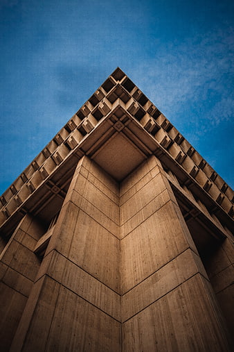 Low angle view of modern concrete building corner against blue sky