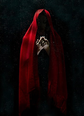 Woman in Red Hooded Cloak with Falling Petals