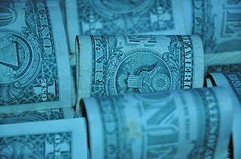 Close-up of rolled US one dollar bills with cool blue tint