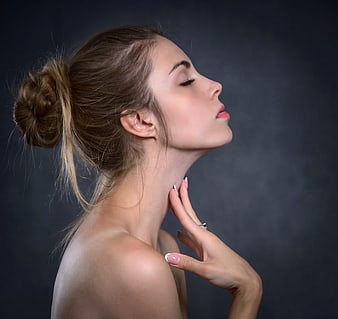 Elegant Profile Portrait of Young Woman with Messy Bun